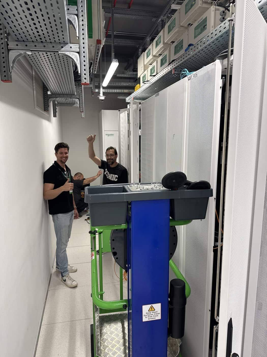 Our engineers in the aisle during the Athens build, thumbs up