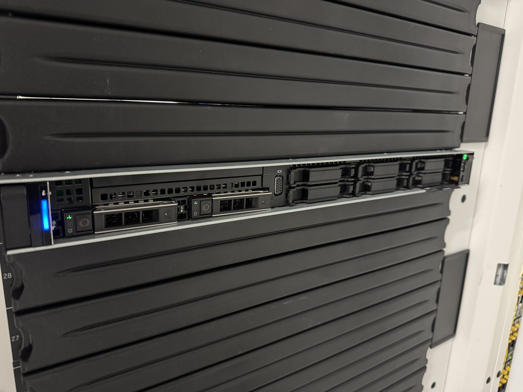 The first server racked in a new cabinet, blanking panels above and below