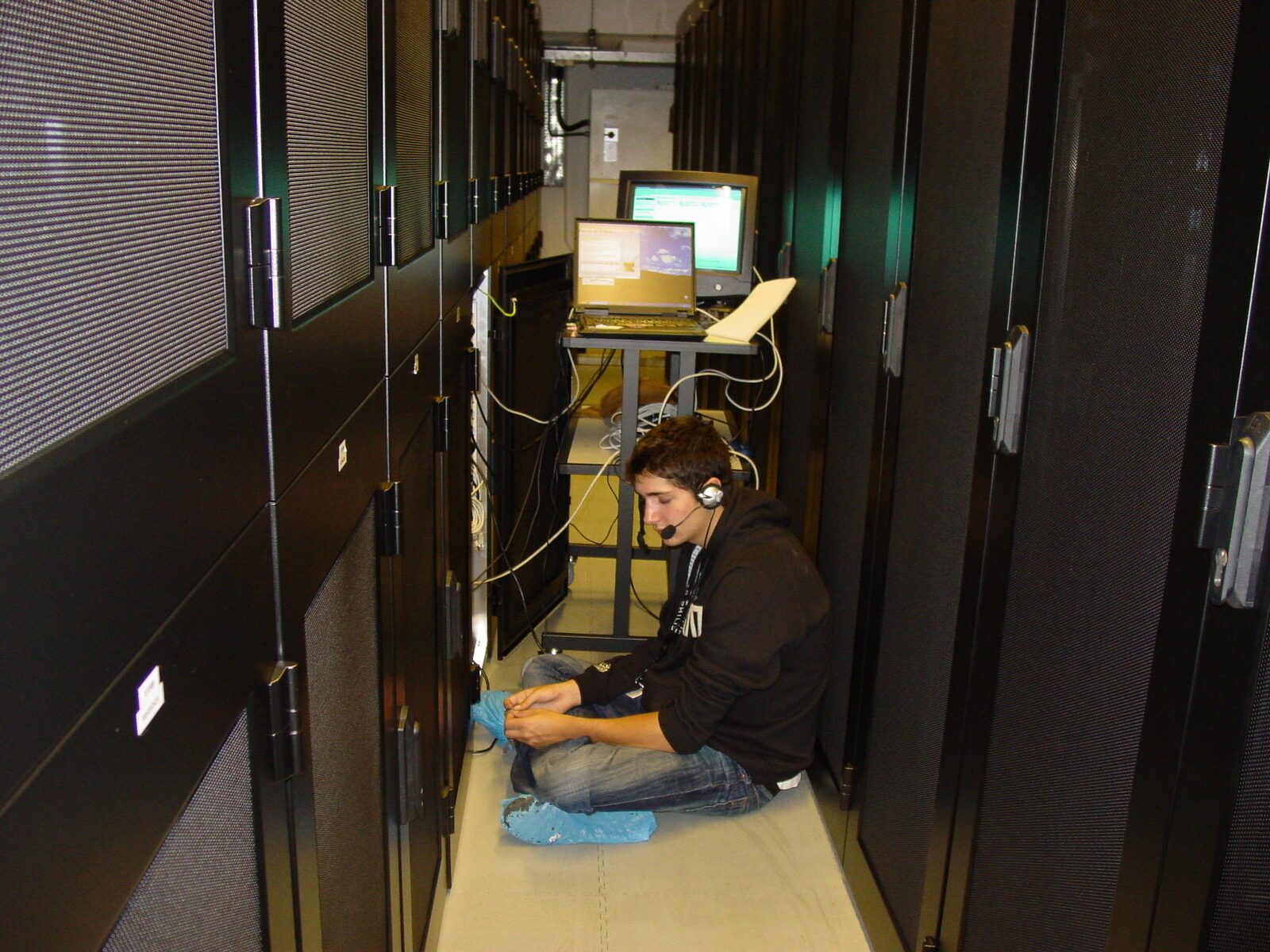 Cross-legged on the datacenter floor with a laptop, 2004
