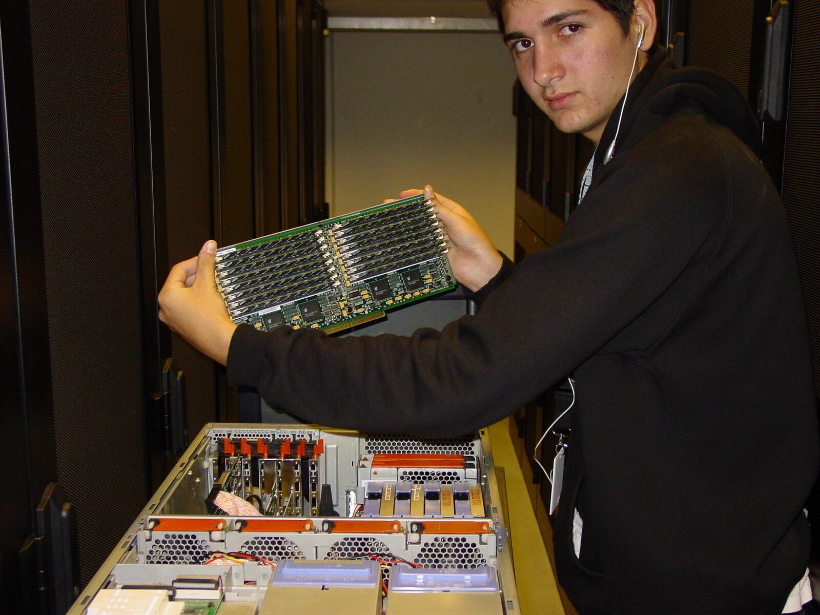 The founder, 21, holding an IBM memory board in the first aisle, 2004
