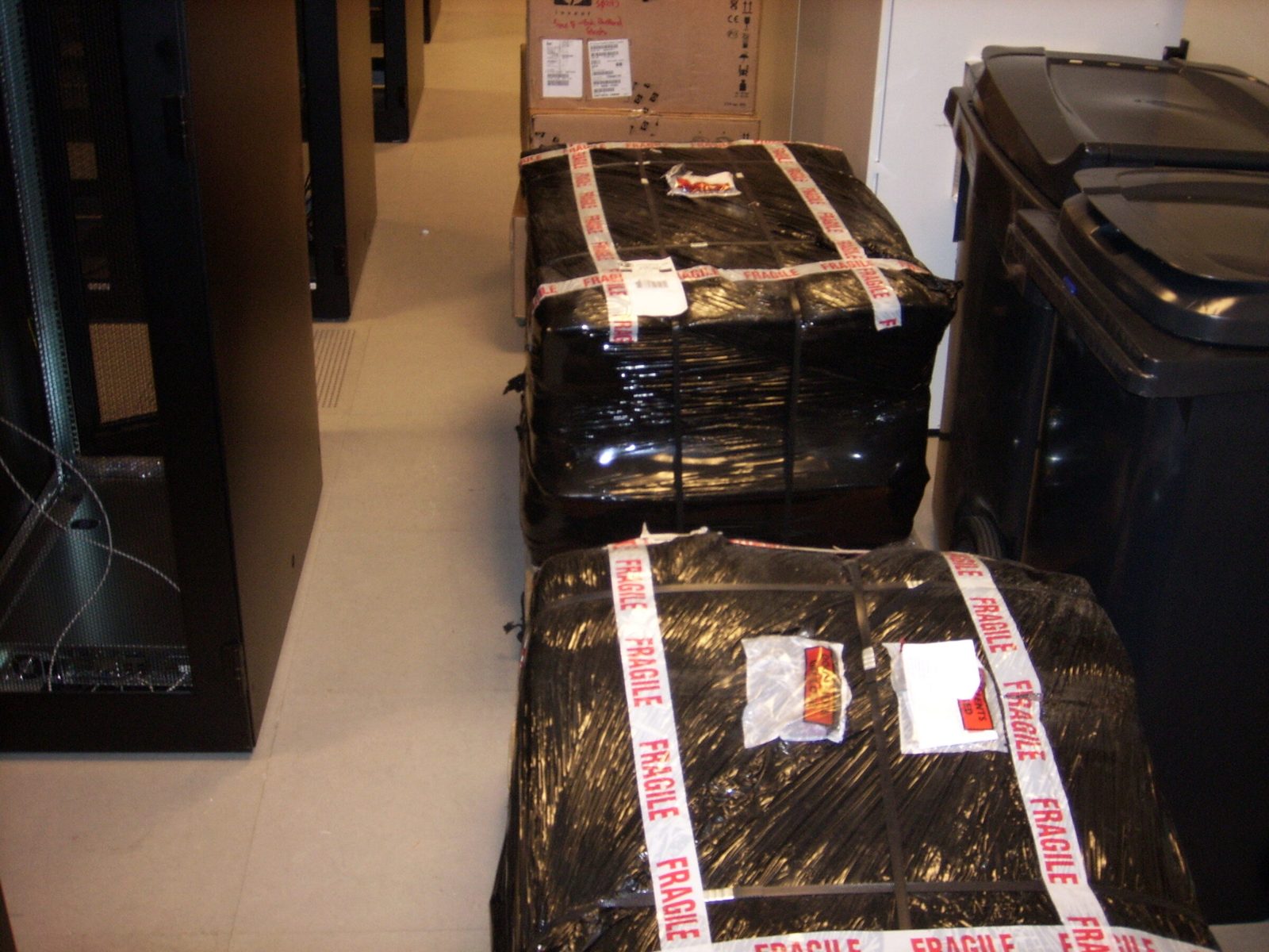 Pallets marked FRAGILE between the cabinets, 2005